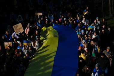 Supporters of Ukraine unfurl a giant flag during a demonstration for the first anniversary of the Russian invasion in Brussels, Belgium on Feb. 25, 2023.