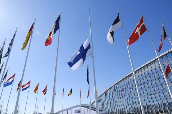 stock image The flag of Finland is hoisted in front of NATO Headquarters during the NATO accession ceremony for Finland in Brussels, Belgium on April 4, 2023.