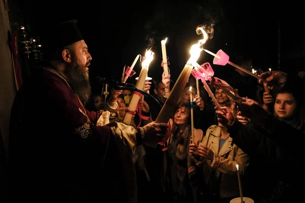 stock image Orthodox Christian priest holds candles during an Easter vigil mass at the church of Saint George in Athens, Greece on April 15, 2023.