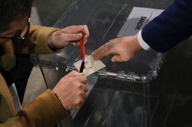 Seçim yetkilileri 29 Nisan 2023 'te Brüksel, Belçika' daki bir sandık merkezinde oy sayarken oy pusulasına balmumu mühür vurdular..