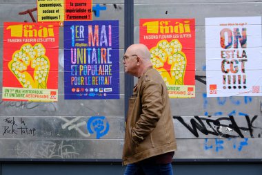 1 Mayıs 2023 'te Paris, Fransa' da düzenlenen yıllık 1 Mayıs işçi mitingi sırasında duvarda İşçi Bayramı kutlamalarının posteri.