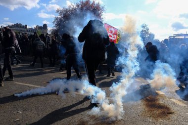 Çevik kuvvet, 1 Mayıs 2023 'te Paris, Fransa' da Fransız emeklilik reform yasasına ve sosyal adalete karşı yapılan seferberlik yürüyüşü sırasında kalabalığı dağıtmak için göz yaşartıcı gaz kullandı..