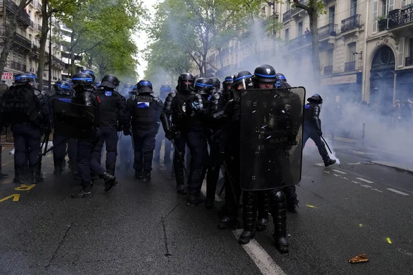 stock image Riot police uses tear gas to disperse the crowd during the May Day labour march, a day of mobilisation against the French pension reform law and for social justice, in Paris, France May 1, 2023.