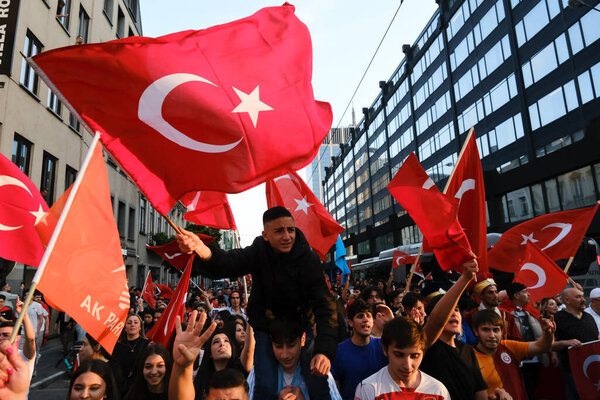 Supporters of Turkish President Erdogan celebrate after the results of the runoff election in Brussels, Belgium on May 28, 2023.