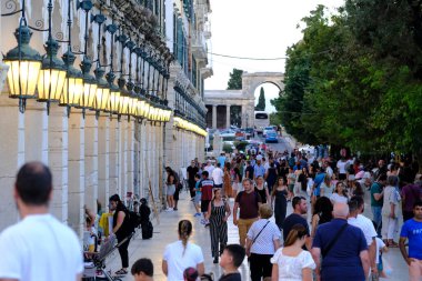 Turistler 1 Eylül 2023 'te Yunanistan' ın eski Corfu kentinde sıcak bir günde yürüyorlar.