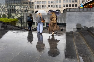 22 Eylül 2023 'te Belçika' da yağış sırasında Brüksel 'in merkezinde yürüyen yayalar.