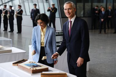 NATO Secretary General Jens Stoltenberg and Foreign Minister Hadja Lahbib cut a cake during a ceremony to mark the 75th anniversary of NATO at NATO headquarters in Brussels, Belgium on April 4, 2024.  clipart
