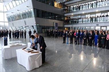 NATO Secretary General Jens Stoltenberg and Foreign Minister Hadja Lahbib cut a cake during a ceremony to mark the 75th anniversary of NATO at NATO headquarters in Brussels, Belgium on April 4, 2024.  clipart