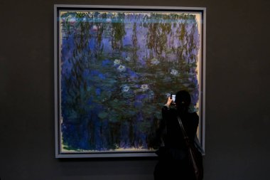 Visitors look at paintings of  artists at the Orsay Museum in Paris, France on March 30, 2024 clipart