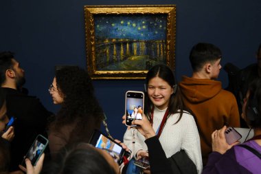 Ziyaretçiler, 30 Mart 2024 'te Paris, Fransa' daki Orsay Müzesi 'ndeki sanatçıların resimlerine bakıyorlar.