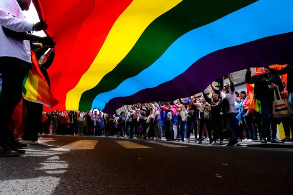 stock image People carry a large rainbow flag at the 'Belgian Pride', a manifestation of lesbian, gay, bisexual and transgender oriented people  in Brussels, Belgium on May 18, 2024.