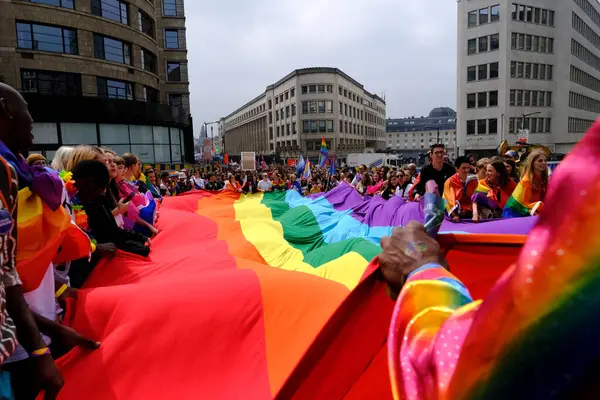 stock image People carry a large rainbow flag at the 'Belgian Pride', a manifestation of lesbian, gay, bisexual and transgender oriented people  in Brussels, Belgium on May 18, 2024.