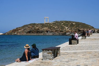 Yunanistan 'ın Naxos Adası' ndaki Delian Apollo antik tapınağının yıkıntıları önünde 3 Mayıs 2024 'te insanlar yürüyor.