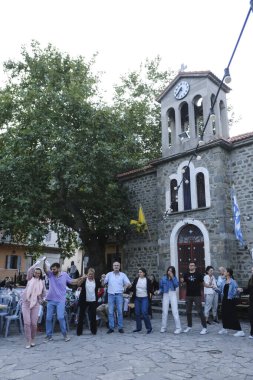 People take part in festivities as they dance traditional folks dances during a festival in Lefka or Paloukova village in Greece on July  27, 2024. clipart