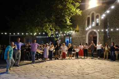 People take part in festivities as they dance traditional folks dances during a festival in Lefka or Paloukova village in Greece on July  27, 2024. clipart