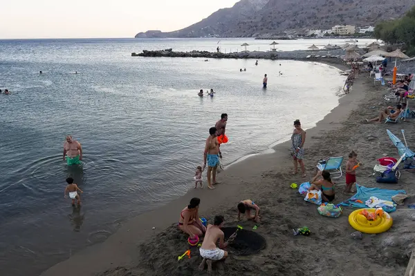 stock image  People enjoy the sea during a hot day in sandy beach of Tsoutsouros, Greece on August 11, 2024. 