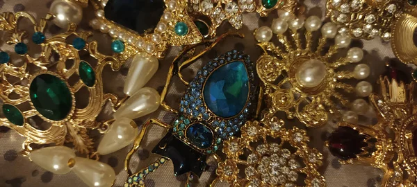 Jewelry vintage at the flea market. Rare things, brooches with stones.