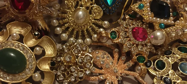 Jewelry vintage at the flea market. Rare things, brooches with stones.