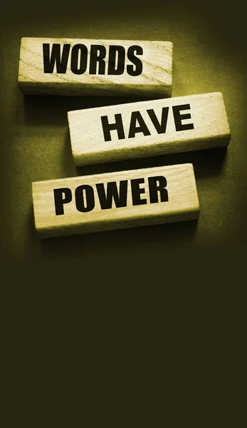 Words Have Power - text on wooden blocks on dark grey background. Powerfull force of communication, storytelling business concept.