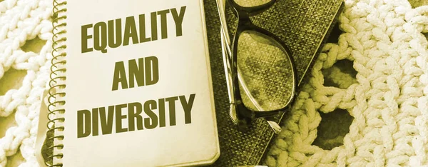 Equality and Diversity on cover of book, eyeglasses and pen Social tolerance concept. in career and education Selective focus.