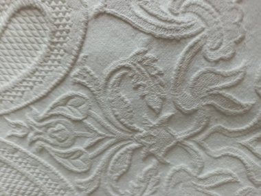 Bir tekstil malzemesinin arka planında beyaz dantel.