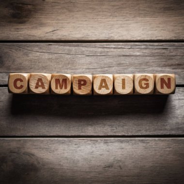 campaign word on cubes with brown background. clipart