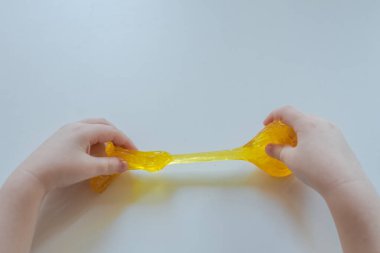 Slime antisress the child plays. Hands of a child. 