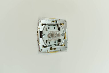 Electricity switch on a white wall. Switch repair. Repair in the