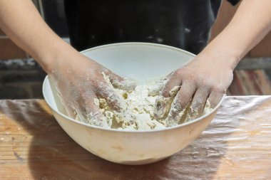 Detail of hands preparing dough clipart