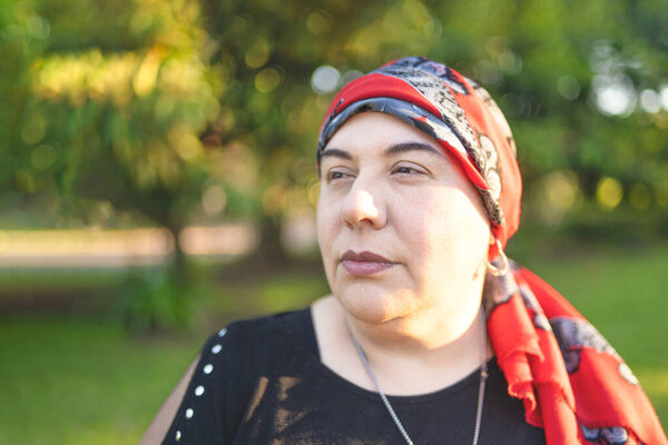 Powerful woman looking away while embracing her difficult health battle