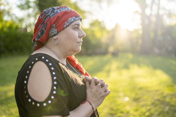 Brave woman with a headscarf contemplating the sunset with hope