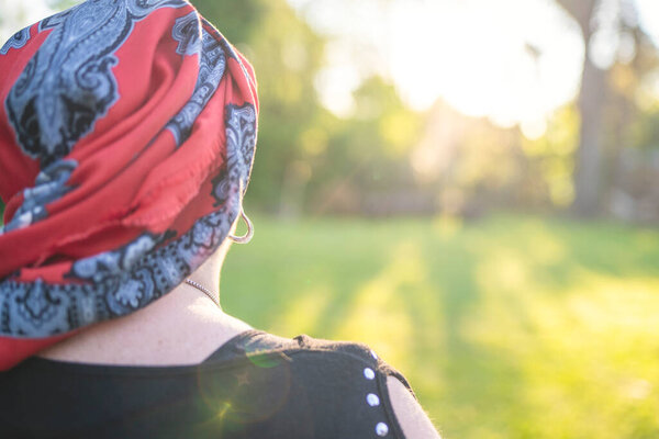 Determined woman with cancer looking towards the future light