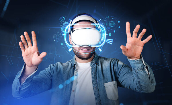 Young man in vr glasses hologram, hands touching something. Online gaming, connection in metaverse. Concept of futuristic technology