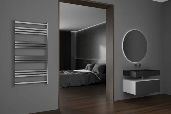 Dark bedroom interior with bed behind door, side view sink with mirror and towel rail on grey wall. Sleeping corner on hardwood floor and washbasin with dresser. 3D rendering