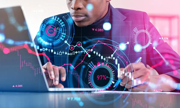 Black businessman take note and working with laptop, double exposure with forex diagrams and candlesticks up and down hologram. Concept of trend analysis