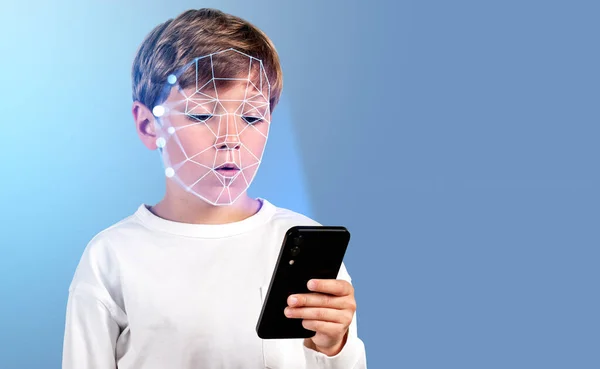 Concentrated boy with smartphone in hand, digital biometric scanning hologram. Face detection and recognition. Concept of face id and education