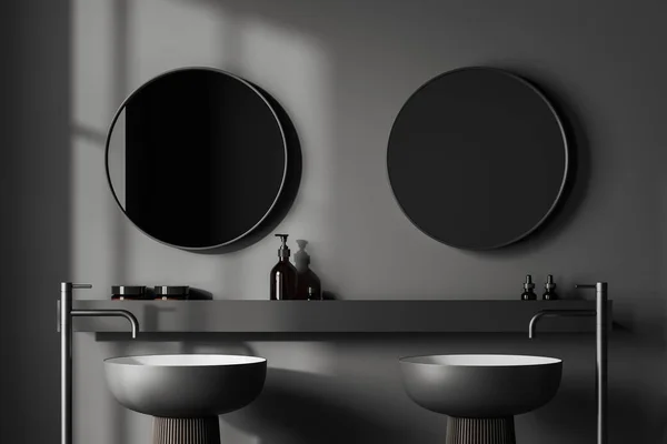 stock image Dark bathroom interior with double sink and shelf with accessories. Two round mirrors and long faucets. 3D rendering