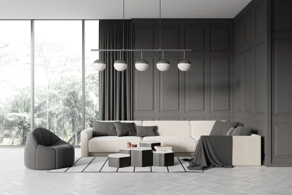 Dark living room interior with sofa, armchair and coffee table on carpet, grey hardwood floor. Stylish relaxing area with panoramic window on tropics. 3D rendering