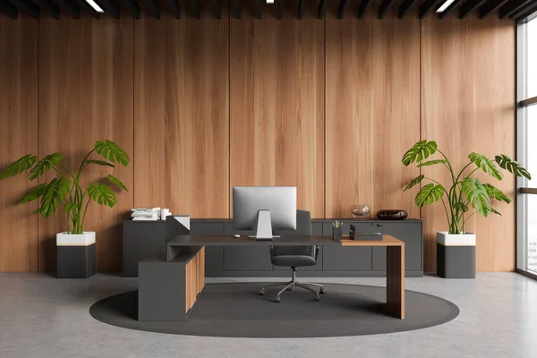 Front view on dark office room interior with desktop, desk, armchair, panoramic window with city view, concrete floor, carpet, sideboard. Concept of company, firm, director workspace. 3d rendering