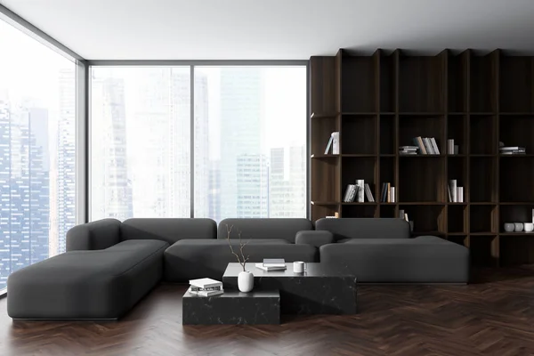 Front view on dark living room interior with panoramic window, sofa, coffee table with books, grey wall, oak wooden hardwood floor, shelves with books. Concept of minimalist design. 3d rendering