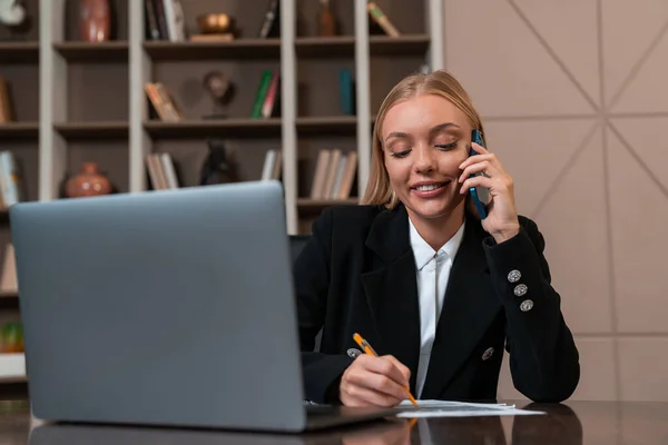 Smiling Businesswoman Take Note Talk Phone Laptop Document Desk Office — Stockfoto