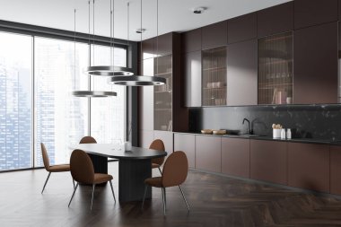 Dark kitchen interior with dining table and cooking area, brown shelves and kitchenware with decoration, side view on hardwood floor. Panoramic window on skyscrapers. 3D rendering