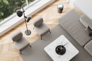 Top view of white living room interior with sofa, two armchairs and coffee table with minimalist decoration. Relaxing corner with panoramic window on tropics. 3D rendering