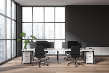 Dark business interior with pc desktop on table and armchairs on hardwood floor. Workspace with pc computers near panoramic window on skyscrapers. Mockup copy space. 3D rendering