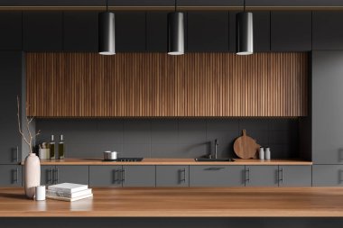 Front view on dark kitchen room interior with good display for advertisement, island, grey wall, books, vase, sink, gas cooker, cupboard. Concept of minimalist design. 3d rendering