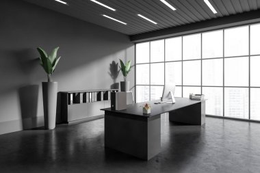 Corner view on dark office room interior with desktop, desk, armchair, panoramic window with city view, concrete floor, carpet, sideboard. Concept of company, firm, director workspace. 3d rendering