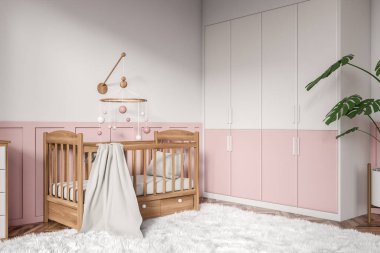 White and pink baby room interior with wooden crib, side view carpet on hardwood floor. Nursery corner with toys, decoration and closed shelf. 3D rendering