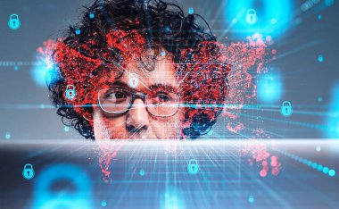 Attentive handsome curly businessman in glasses working on laptop. Digital interface with red map hologram, padlocks in background. Concept of cybersecurity, data protection, cyberattack