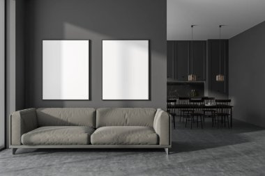 Dark studio flat interior with sofa, dining table with chairs on background. Relaxing and eating area in modern apartment. Two mockup posters in row. 3D rendering