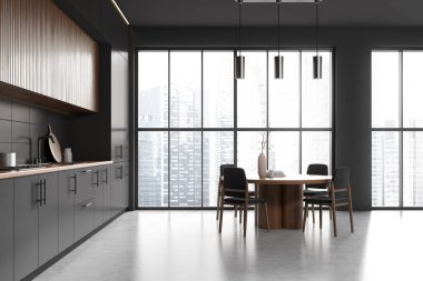Stylish kitchen interior with dining table and chairs, grey concrete floor. Cooking area with shelves and kitchenware, panoramic window on skyscrapers. 3D rendering